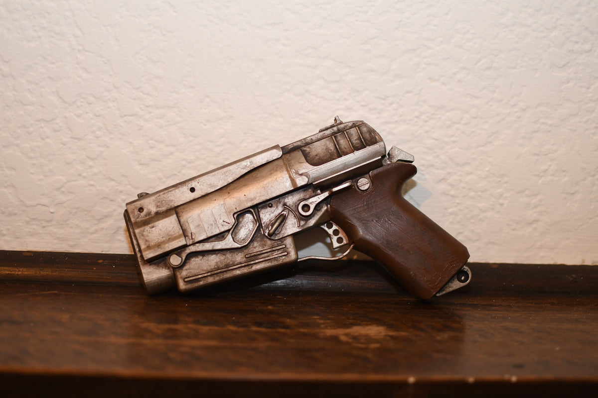 Toy gun on a wooden surface with a neutral background