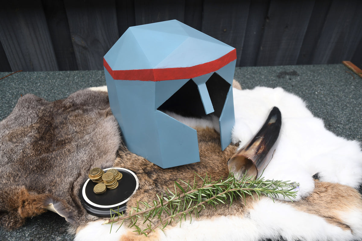 Blue helmet with red band on a deer head with antlers and rosemary.